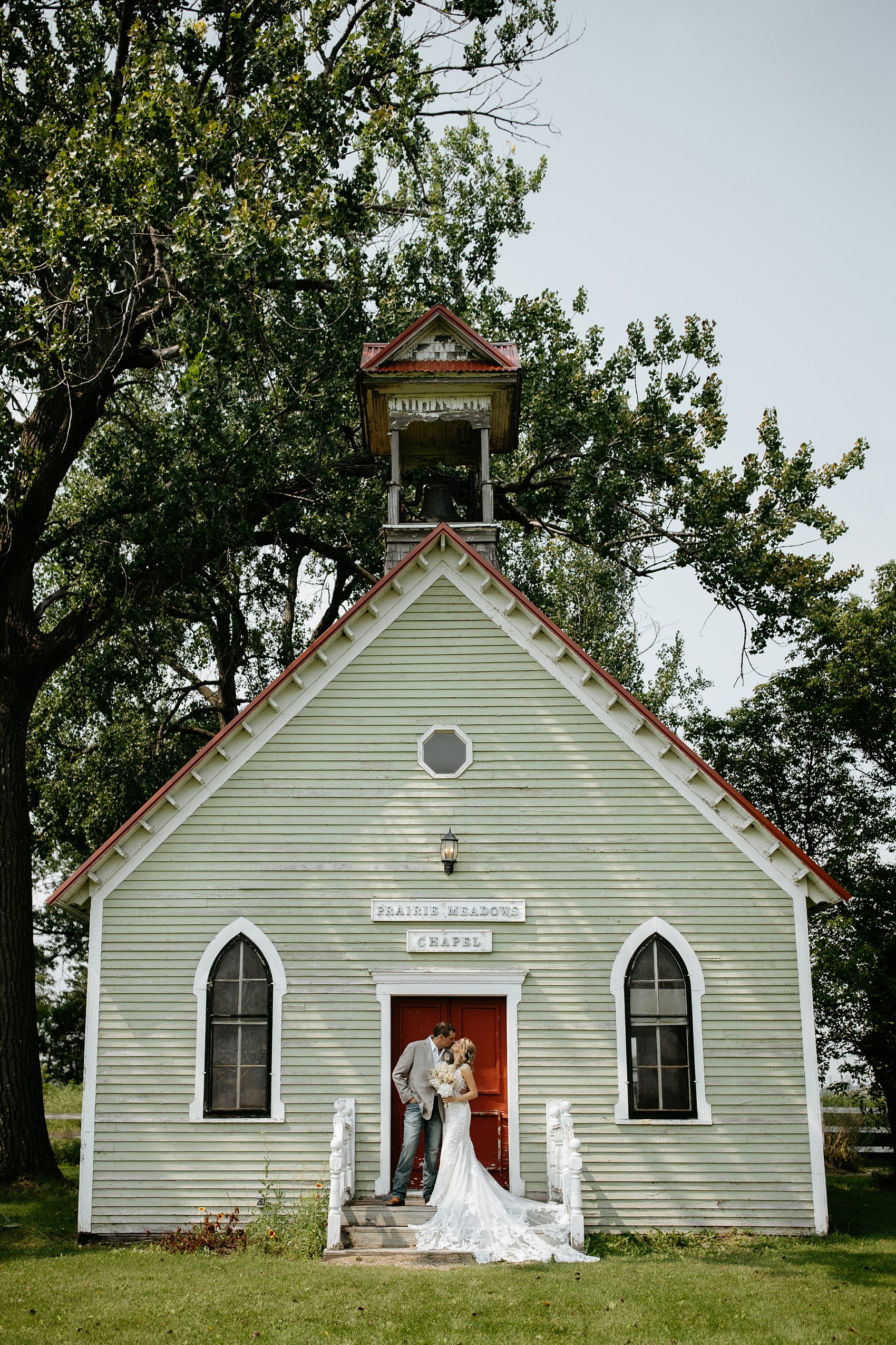 The bride and groom have their first look in the Prairie Meadows Venue chapel.