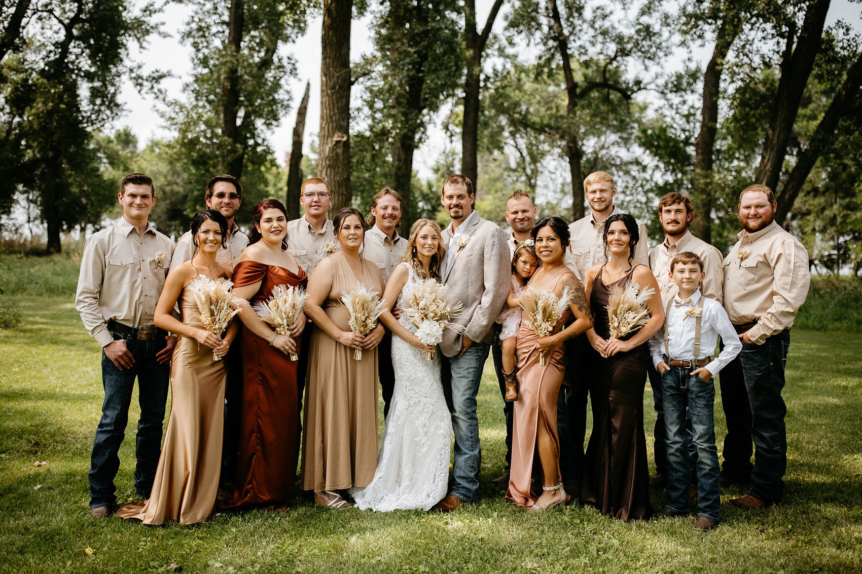 The wedding party was the perfect mix of boho and western for this Prairie Meadows Venue wedding.