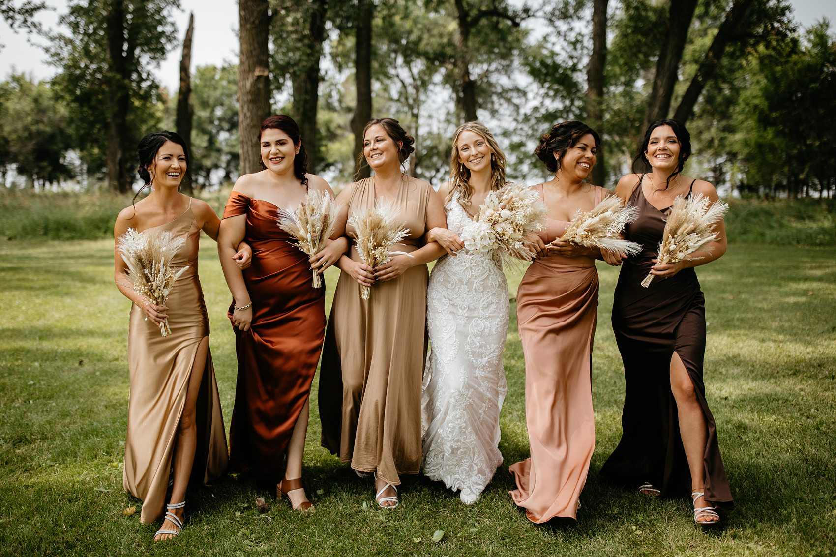 The wedding party was the perfect mix of boho and western for this Prairie Meadows Venue wedding.